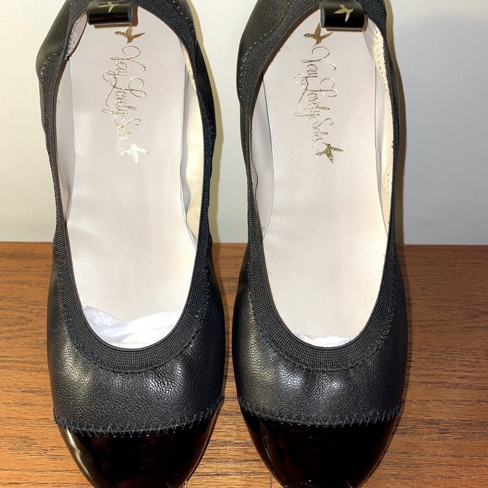 Black leather/patent leather ballet flats. Never worn. New in the box.